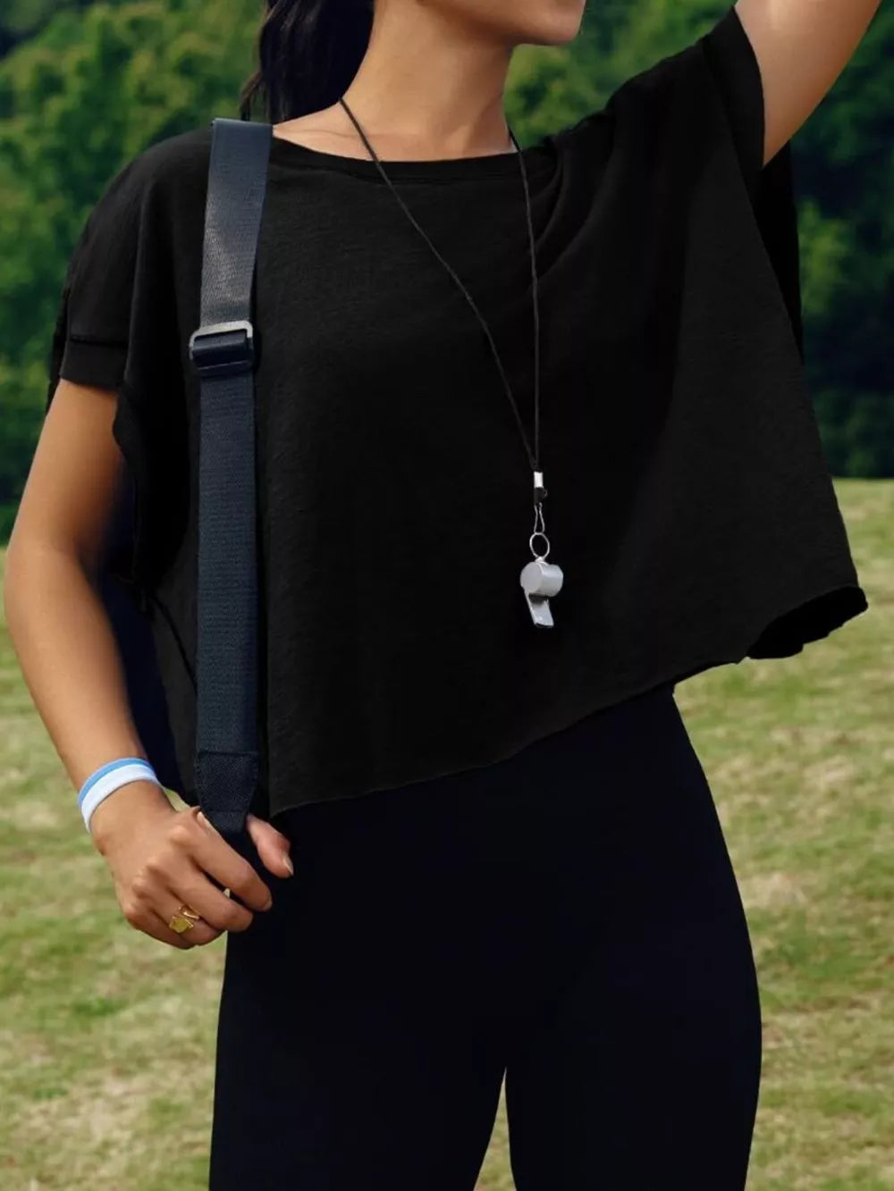 Black t-shirt with exposed seams and cutout back detail.