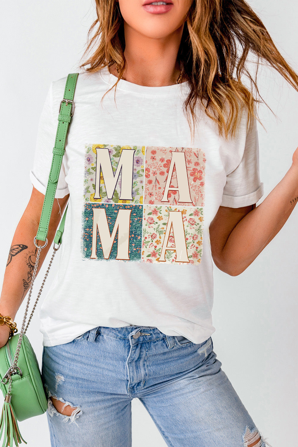 White t-shirt with floral collage "MAMA" graphic, short sleeves, crew neck.
