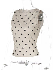 Chic polka dot tank top in cream with black dots, cropped length, and sleeveless design.