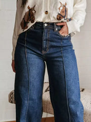 Dark blue denim wide-leg jeans with buttoned pockets and contrast stitching.
