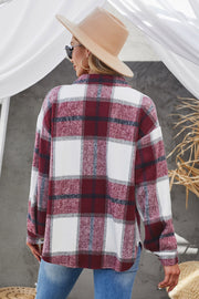 Oversized shacket in burgundy plaid with button-down front and patch pocket.