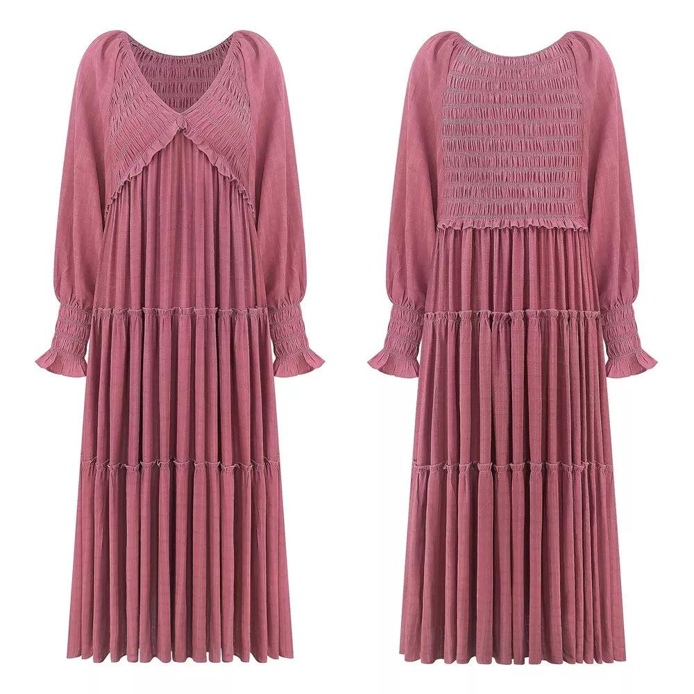 Smocked V-neck tiered maxi dress in dark pink with long sleeves and ruffled cuffs.