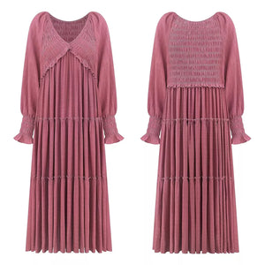 Smocked V-neck tiered maxi dress in dark pink with long sleeves and ruffled cuffs.