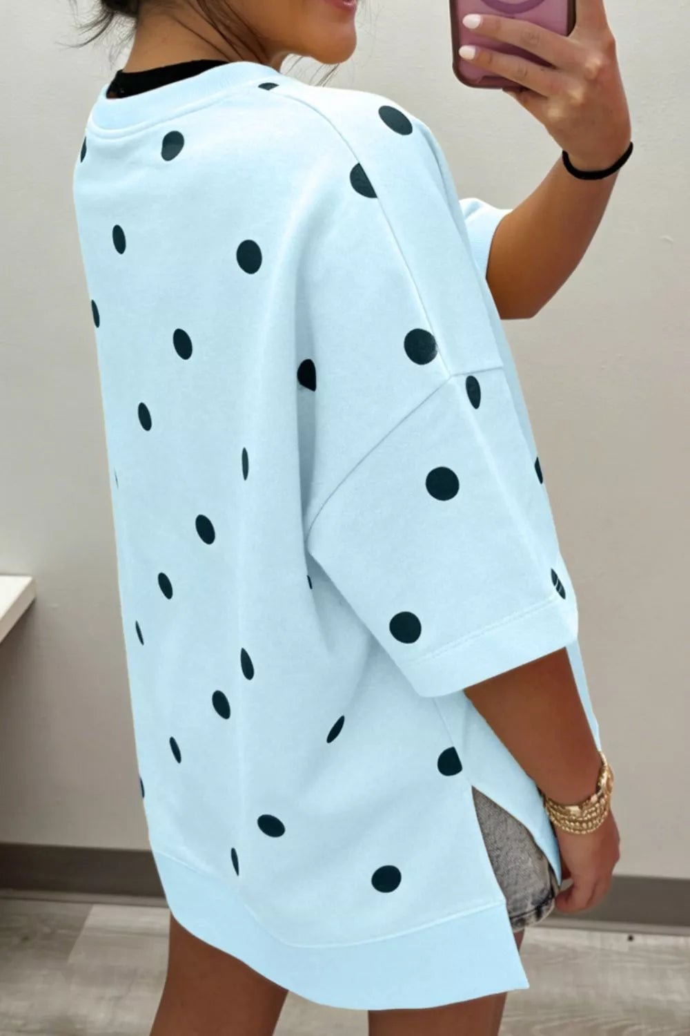 Light blue polka dot oversized t-shirt with short sleeves and side slits.