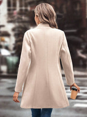 Sculpted flare-hemmed overcoat in Dust Storm wool blend, shown from the back.