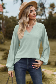 Light green waffle knit raglan sweater with laser cut sleeves and v-neck