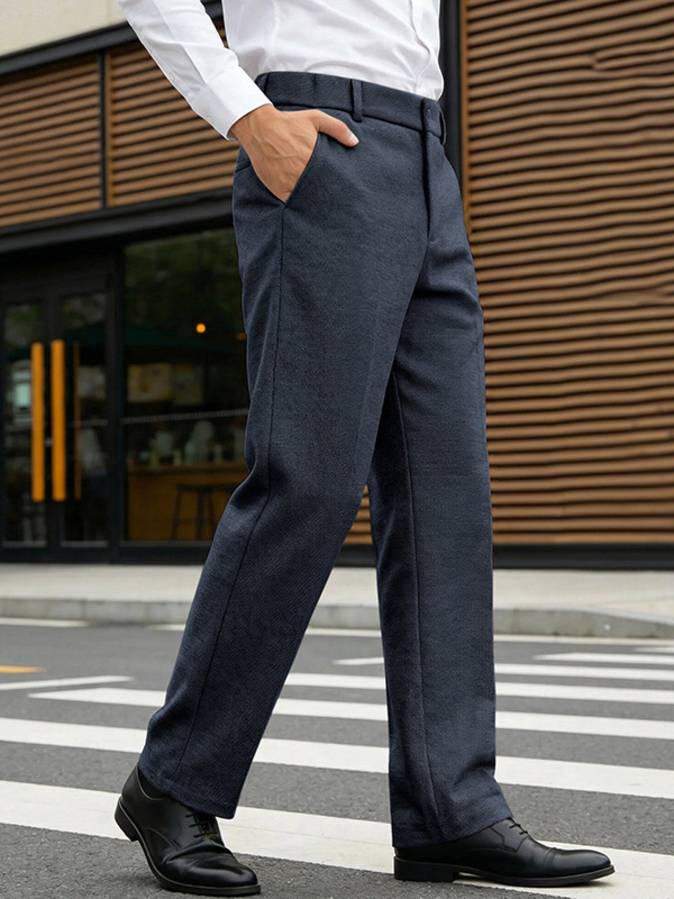 Classic fit navy dress pants with pockets, straight leg, shown on a man walking.