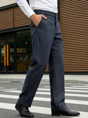 Classic fit navy dress pants with pockets, straight leg, shown on a man walking.