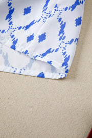 Patchwork babydoll maternity overshirt in white with blue abstract pattern and puff sleeves.