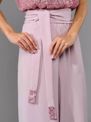 Pink wide-leg jumpsuit with sequin tie detail and sequin cuffs.