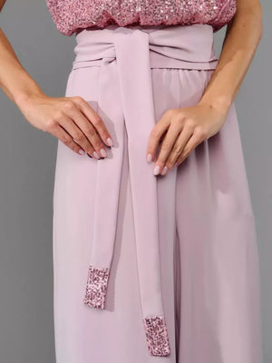 Pink wide-leg jumpsuit with sequin tie detail and sequin cuffs.