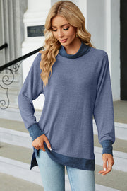 Colorblock raglan turtleneck tunic in dusty blue with contrast trim and cuffs.