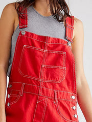 Crimson denim short overalls with contrast stitching and button side details.
