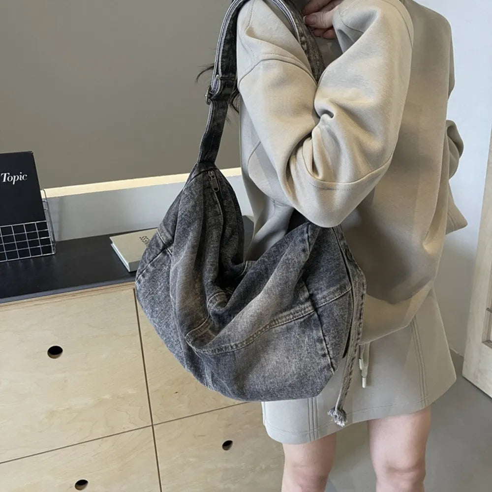 Washed denim hobo bag in medium with a slouchy silhouette and adjustable strap.