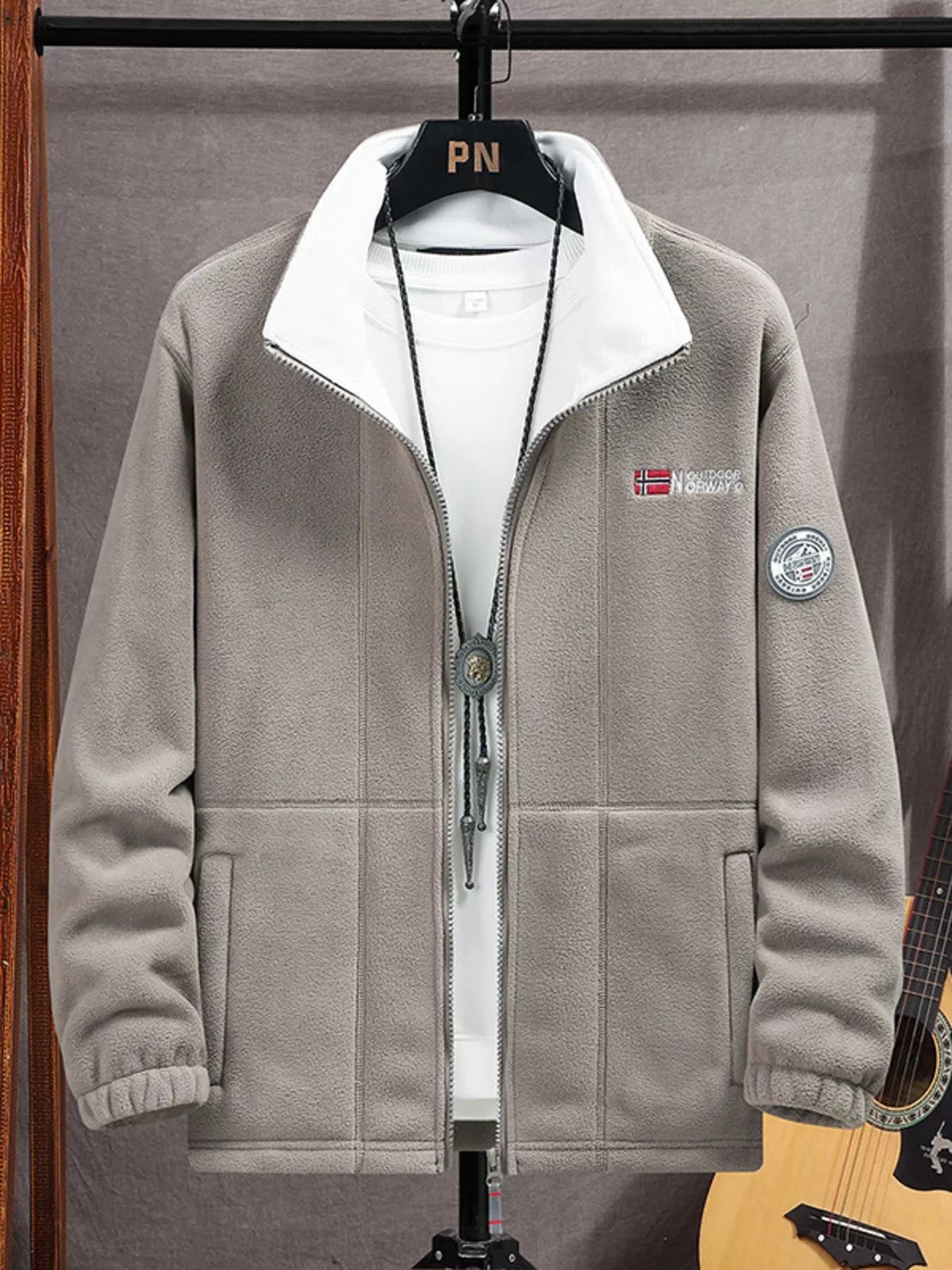 Men's grey fleece zip-up jacket with white collar and embroidered details.