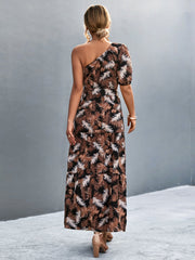 Tropical print one-shoulder maxi dress in black with a tiered skirt and puff sleeve.