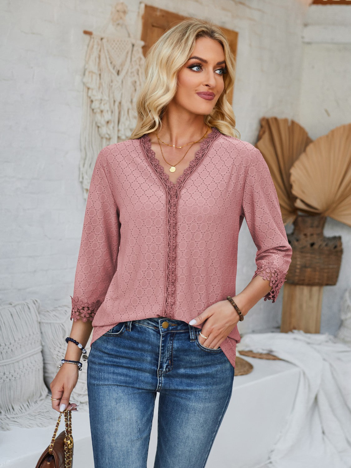 Dusty pink eyelet trim V-neck blouse with 3/4 sleeves and lace cuffs.