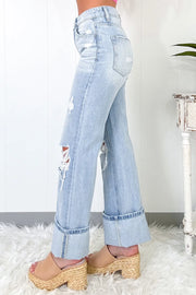 Light wash distressed wide-leg jeans with cuffed hems and ripped details.
