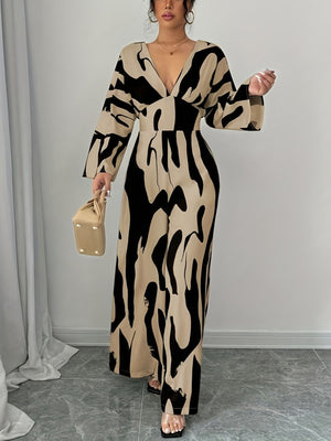 Abstract print wide leg jumpsuit with V-neck and belted waist.