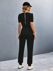 Black puffed sleeve jumpsuit with back cut-out detail and elastic waist.