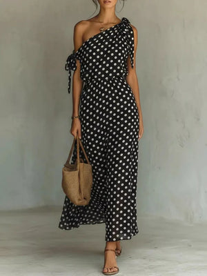 Black polka dot one-shoulder maxi dress with cinched waist and tie details