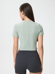 Sage cropped performance crew neck top with short sleeves and a seam down the back.