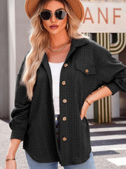Textured oversized black button-down shacket with collared neckline and chest pockets.