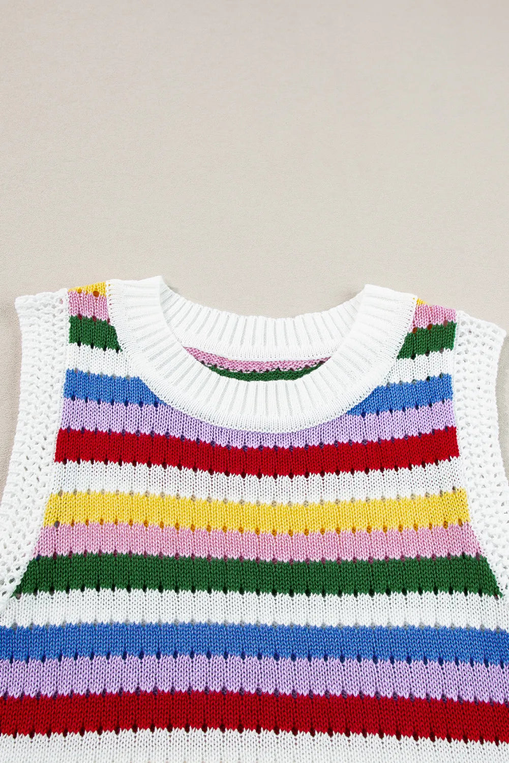 Rainbow stripe crochet tank top with white ribbed neckline and open knit sides.