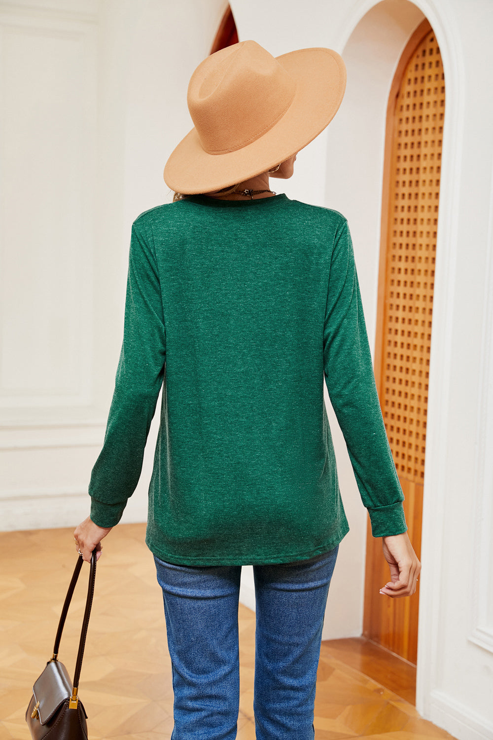 Dark green long sleeve Henley-inspired top with crew neck and button detail