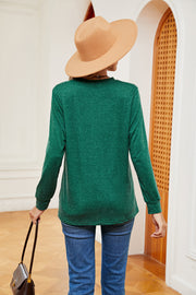 Dark green long sleeve Henley-inspired top with crew neck and button detail