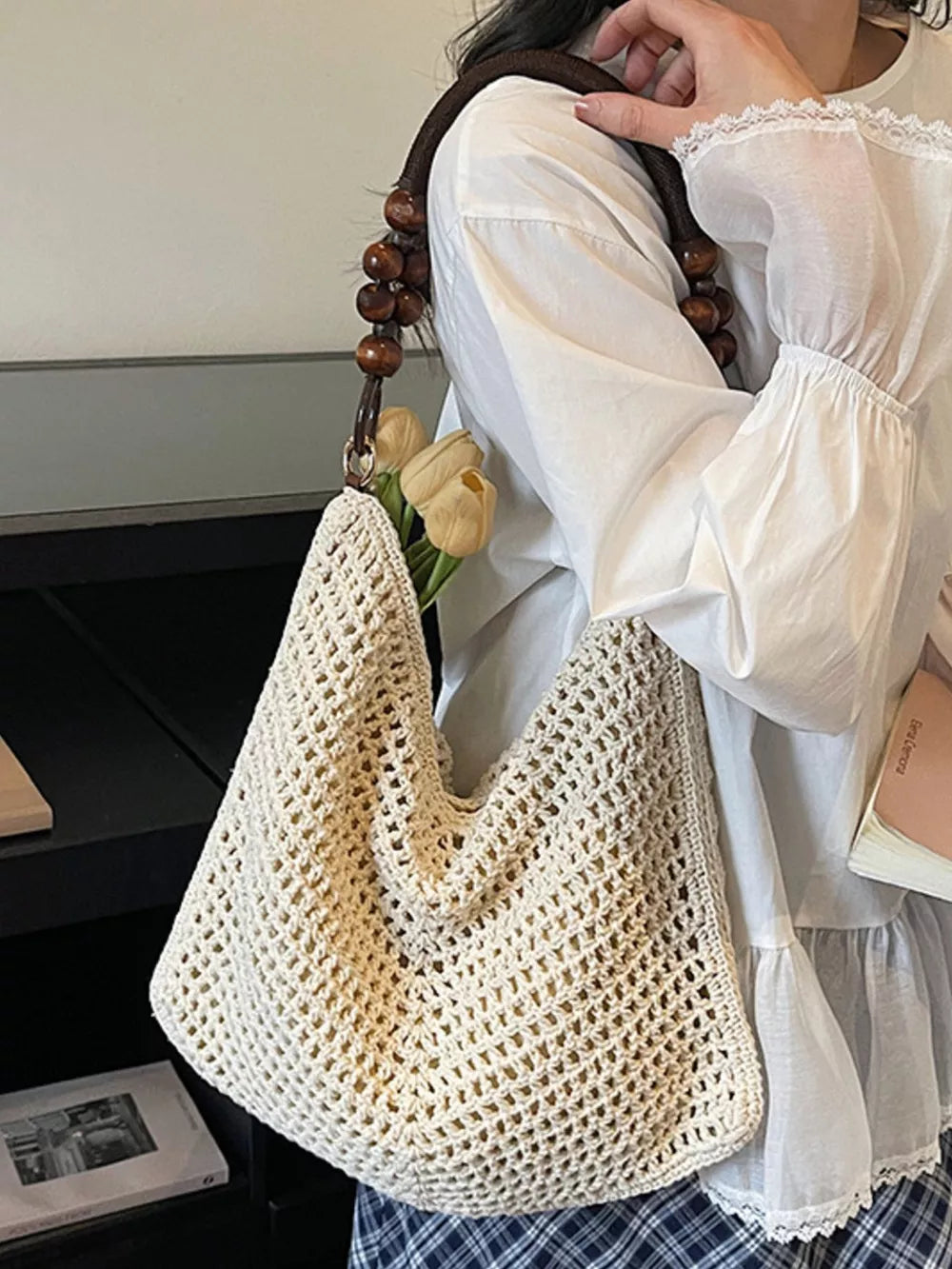 Ivory knit shoulder bag with beaded handle and open weave detail