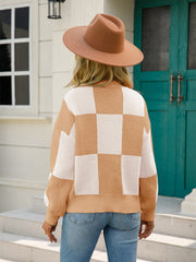 Checkerboard knit pullover sweater in khaki and white with balloon sleeves.