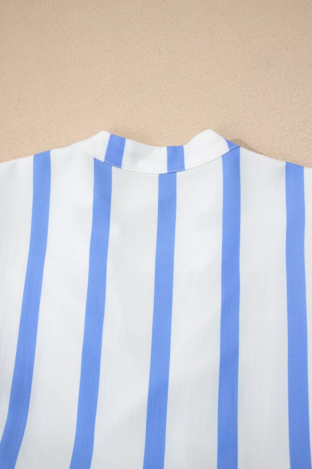 White and blue striped dress with a stand collar detail.
