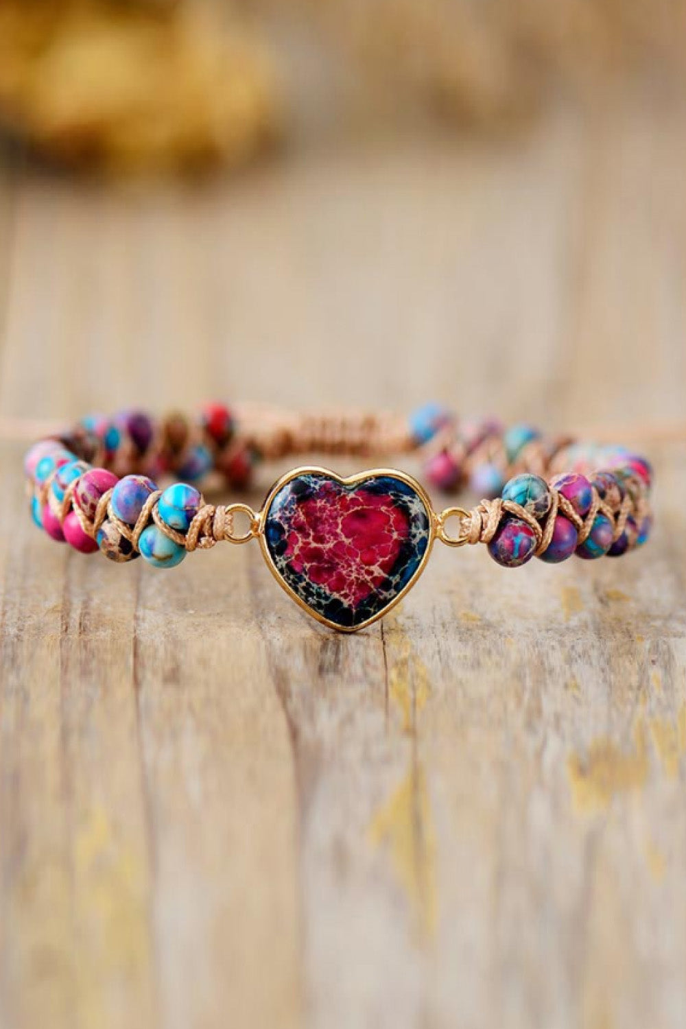 Multicolor beaded bracelet with a heart-shaped stone charm and goldtone accents.