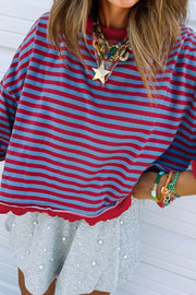 Striped sweatshirt with red and blue horizontal stripes, red trim, and pearl-embellished skirt.