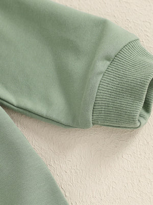 Green cotton baby outfit with ribbed cuffs and applique detail.