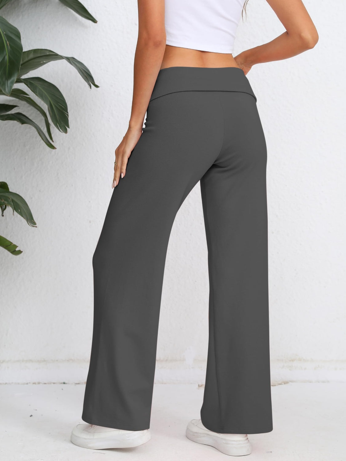 Dark gray palazzo trousers with a fold-over waistband, shown from the back.