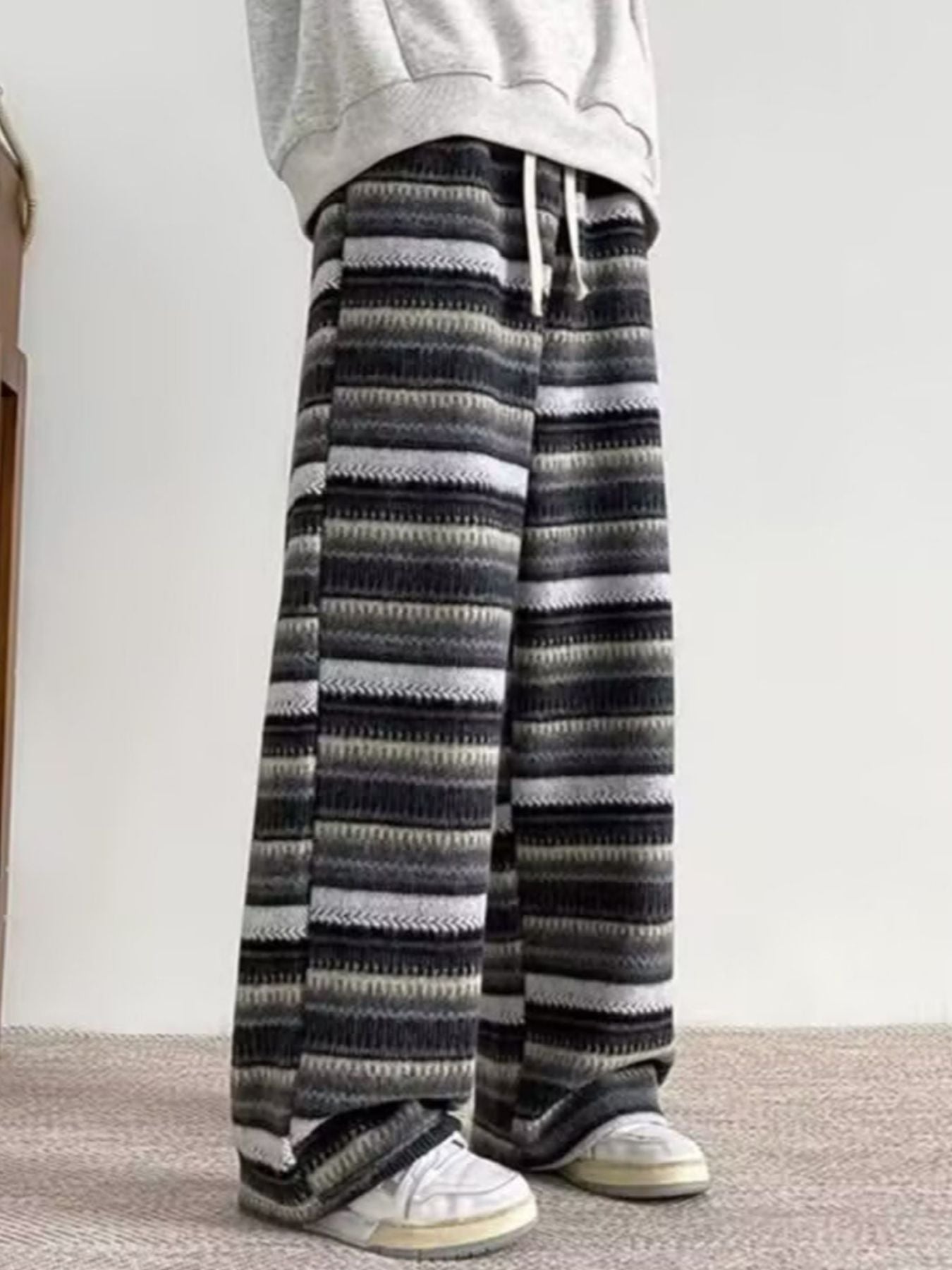 Men's wide-leg pants with drawstring and horizontal stripe pattern in gray tones.