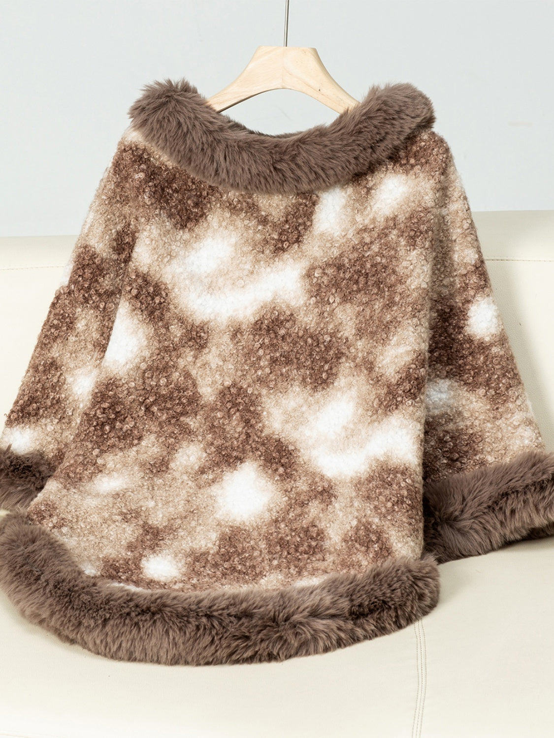 Faux fur trimmed camo poncho in Chocolate with a fuzzy texture and open front.