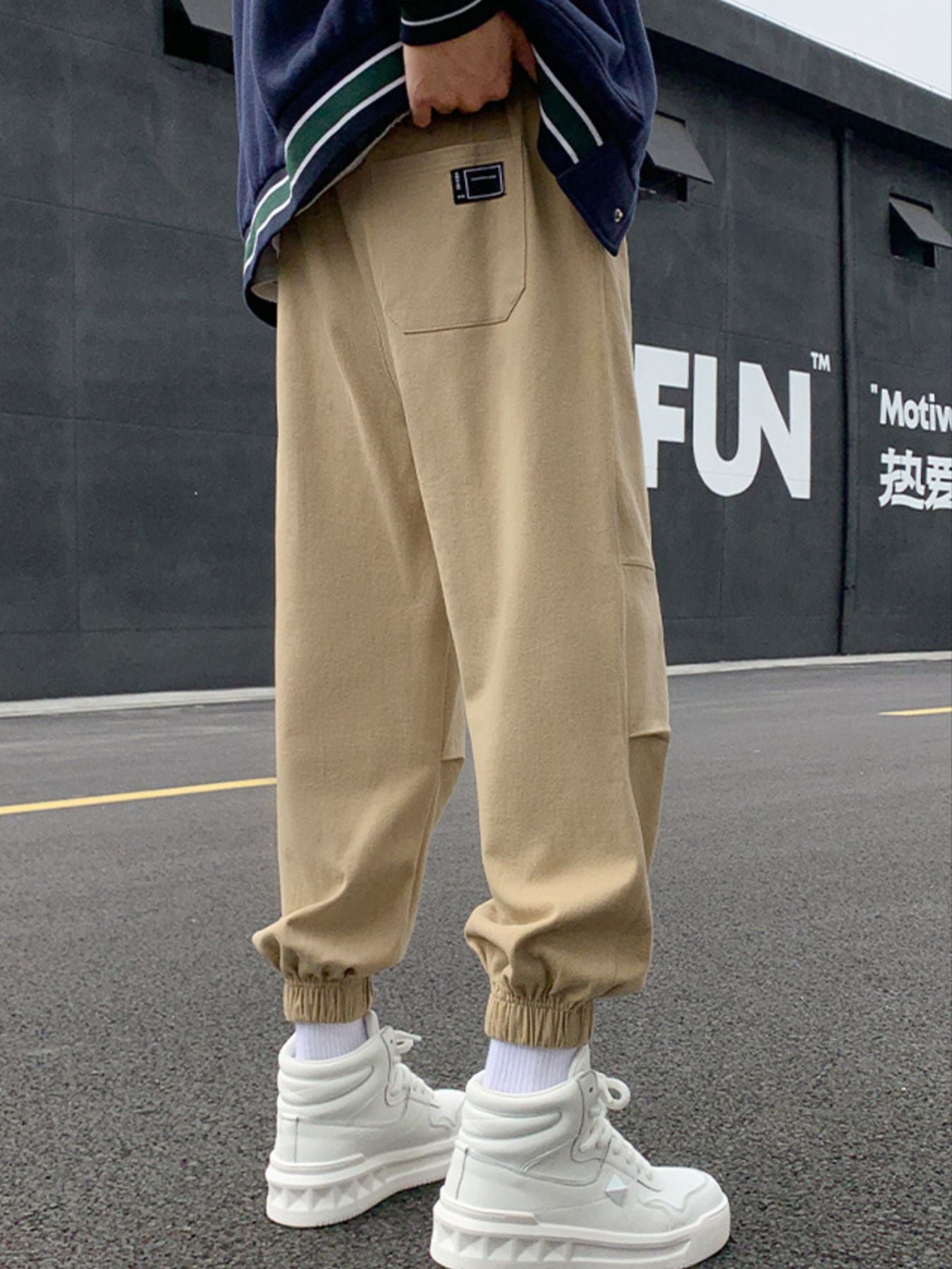 Khaki relaxed fit joggers with pockets and elastic cuffs.