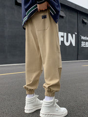 Khaki relaxed fit joggers with pockets and elastic cuffs.