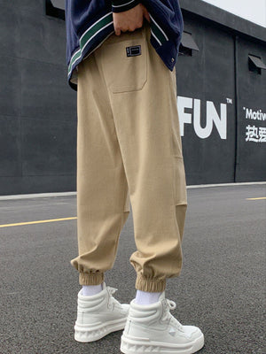 Khaki relaxed fit joggers with pockets and elastic cuffs.