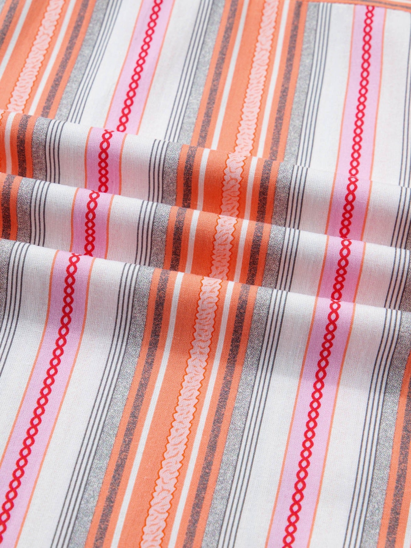 Classic button-down shirt in cotton with orange, pink, and gray stripes and decorative trim.