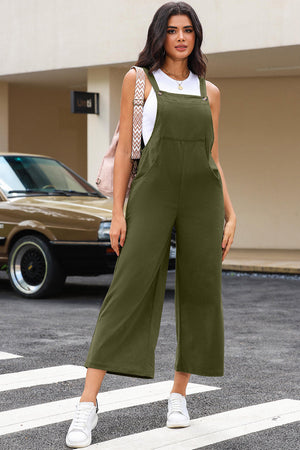 Army green corduroy overalls with wide leg silhouette and buttoned straps.