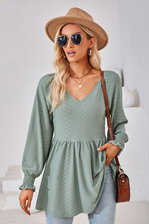 Sage textured babydoll blouse with V-neck and smocked cuffs