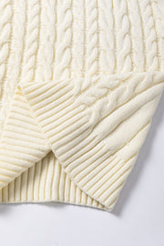 Ivory cable knit mock neck vest with ribbed hem and textured knit detail.