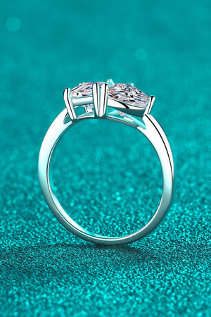 Silver dual-cut moissanite engagement ring with a four-prong setting.