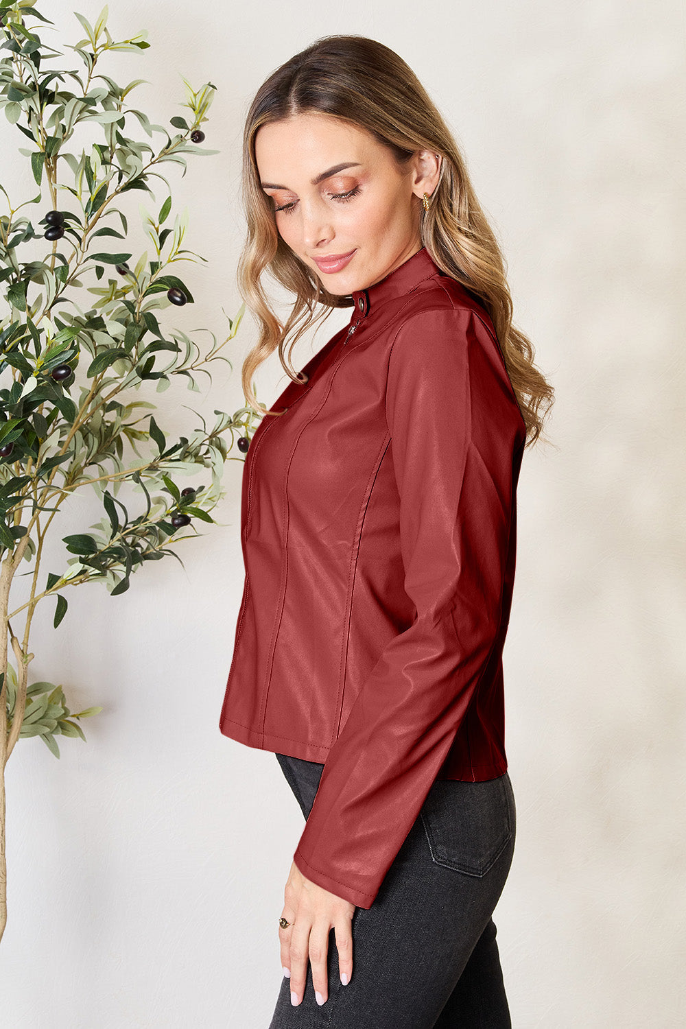 Biker-inspired faux leather jacket in Red Orange with a stand-up collar and zip closure.