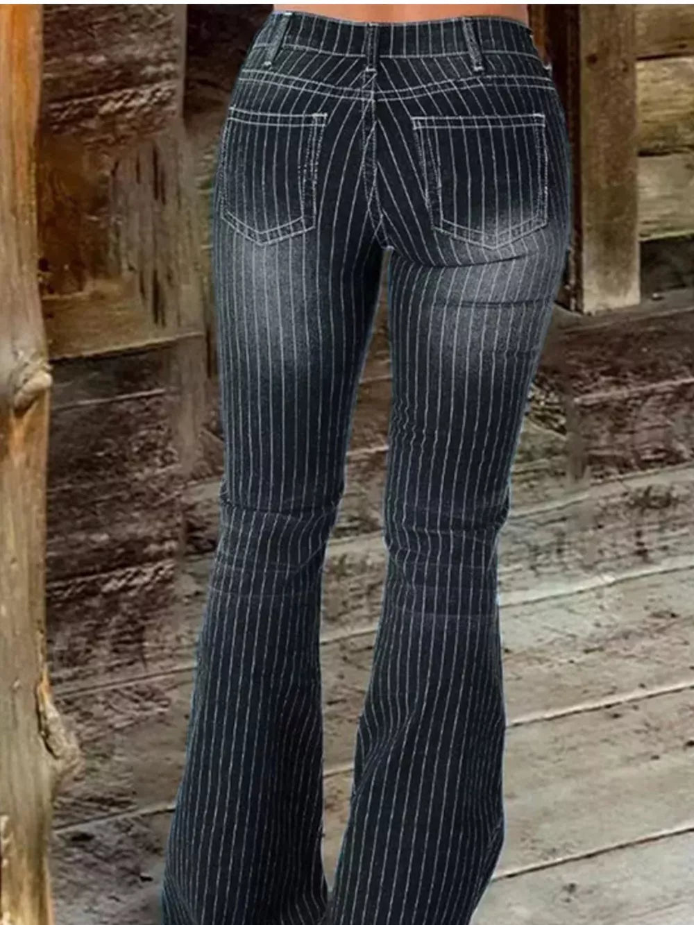 Black pinstripe flare maternity jeans with button fly and distressed denim detail.