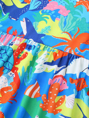 Toddler a-line dress with vibrant ocean print, featuring sharks, octopuses, fish, and coral.